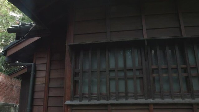 Closeup details of wooden slat bars covering asian styled house of Tada Eikichi