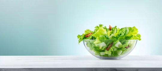 Poster Salad vegetables in glass bowl on table on light background side view, healthy lifestyle concept, empty space horizontal panoramic banner © Yulia