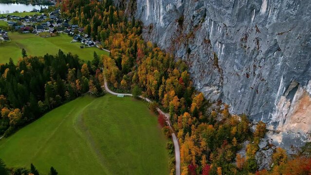 Aerial view following a trail to a town near Lake Toplitz, fall day in Austria