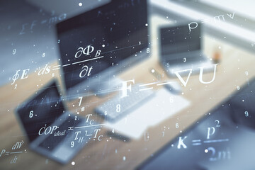 Double exposure of creative scientific formula concept and modern desktop with laptop on...