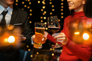 food and drink male friends are happy drinking beer and clinking glasses at a bar or pub.