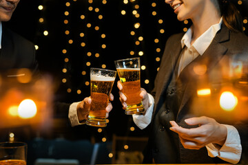 food and drink male friends are happy drinking beer and clinking glasses at a bar or pub.