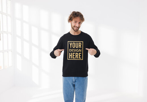 Mockup of man wearing customizable sweatshirt pointing at chest