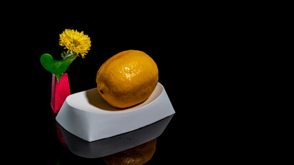 Composition with lemon bathing on a black background