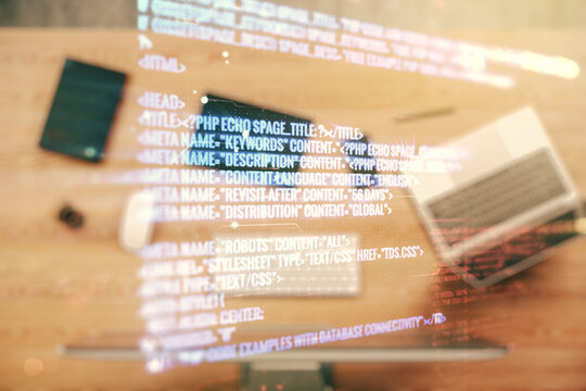Double exposure of abstract programming language on laptop background, research and development concept