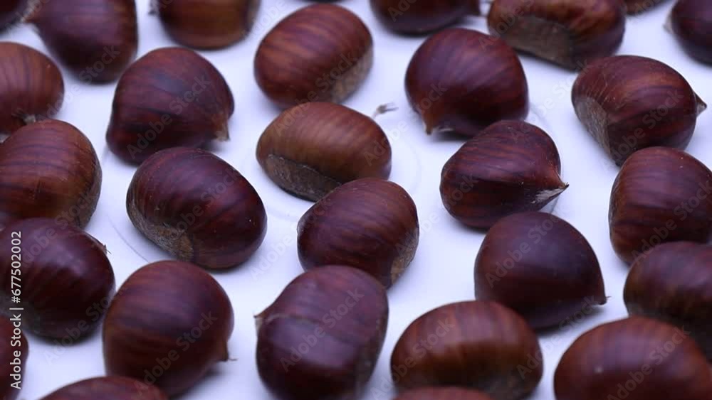 Poster raw chestnuts rotating on a turntable.