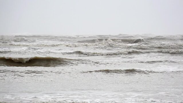 In slow motion dark, moody and threatening waves are whipped up by strong winds roll in before storm Ciar&aacute;n makes landfall.