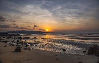 Sunrise over Edgecumbe Bay with rocks and reflections in Bowen, Queensland, where the film, Australia, was filmed.