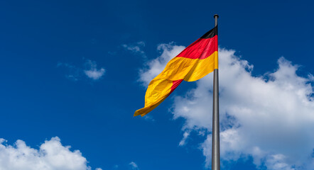 flag of the Democratic Republic of Germany against the summer sky