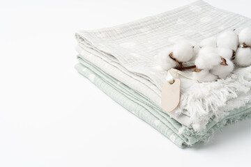 Muslin baby blankets with cotton flowers on white background
