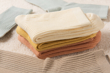 Colorful socks laid out on plush blanket background
