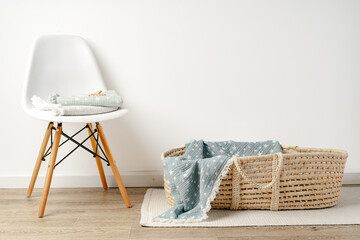 Baby cradle with muslin blanket and wooden toys in a baby room - obrazy, fototapety, plakaty