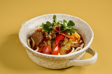Savory Beef Lagman with Vegetables in Ceramic Bowl