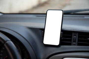 phone with isolated screen on the dashboard while driving in a car