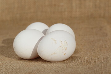 group of white eggs on burlap