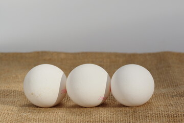 group of white eggs on burlap