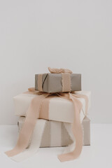 Christmas, New Year composition. Stack of handmade winter holidays gift boxes with bows and ribbons. Festive packaging concept