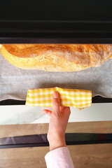 Woman's hands taking fresh bakery out of mini oven