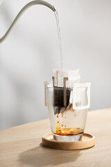 Brewing coffee through pre-made paper filters.