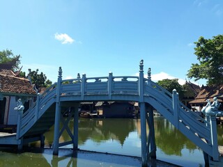 The bridge with Blue color - a connection between river banks.The image of the bridge crossing between each canal conveys the journey, communication, and the encounter with someone upon crossing this 