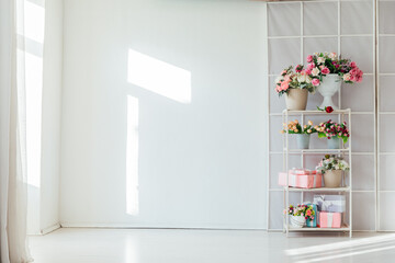interior of the shelf with flowers in a bright room for the holiday