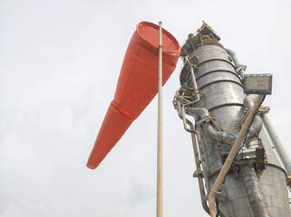 The wind indicator windsock functions as a marker of wind direction in the chemical factory area