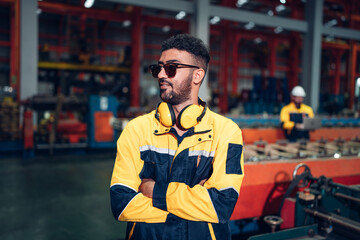 Fototapeta premium Portrait of Smiling Professional Industry Engineer standing and looking camera, Worker Wearing Safety Uniform and Hard Hat at factory. Machine maintenance technician operation concept.