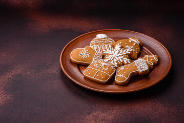 Beautiful Christmas gingerbread cookies of different colors on a ceramic plate
