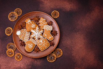 Beautiful Christmas gingerbread cookies of different colors on a ceramic plate