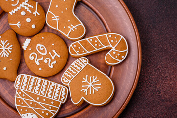 Beautiful Christmas gingerbread cookies of different colors on a ceramic plate