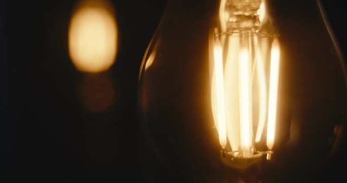 LED light bulbs turn on and off electrical device shine dark close up