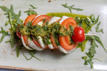 Caprese skewers with pesto sauce