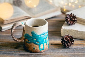 Obraz na płótnie Canvas Cozy winter composition with a handmade cup and books.