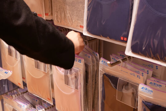 Motion of woman buying clothes inside uniqlo store