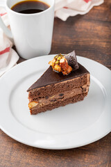 Delicious chocolate and pistachio cake on dark wooden background