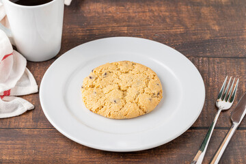 Bitter almond cookies or turkish name acibadem kurabiyesi with coffee on wooden table