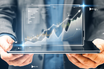 Businessperson holding a tablet with stock market growth chart