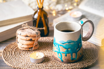 Cozy autumn composition with a handmade cup close-up.