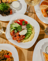 Healthy salmon bowl. Healthy food. Fresh bowl with avocado, salmon, couscouse, cucumber and cream cheese