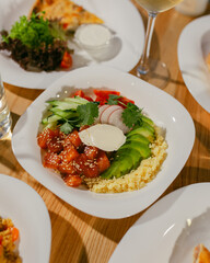 Healthy salmon bowl. Healthy food. Fresh bowl with avocado, salmon, couscouse, cucumber and cream cheese