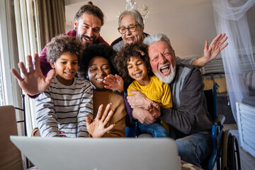 Extended multiethnic family together at home during video call. People happiness technology concept