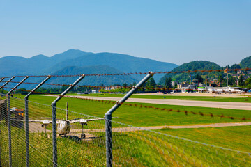 Lugano Airport Runway with Mountain Viewand Clear Sky in a Sunny Day in Ticino, Switzerland.