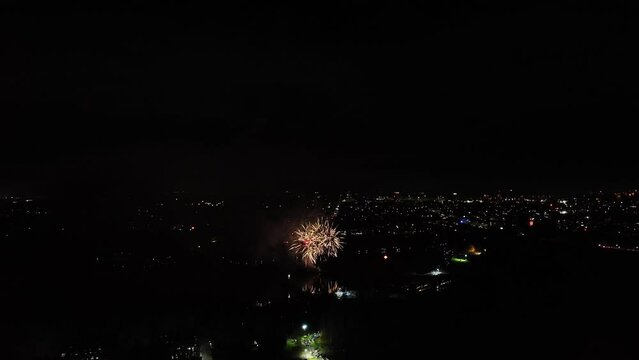Aerial shot of a vibrant firework display going off at new years eve for the new year