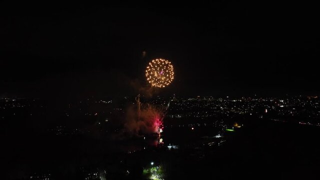 Aerial shot of vibrant fireworks exploding at night in the UK