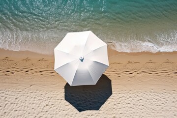 Aerial view of sandy beach with umbrella and blue water. Generative AI