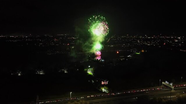 Aerial dolly shot of fireworks being set off on bonfire night in the UK