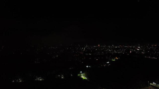 Aerial revealing shot of large fireworks exploding on guy fawkes night in the UK