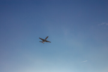 Fototapeta na wymiar Airplane against blue sky
