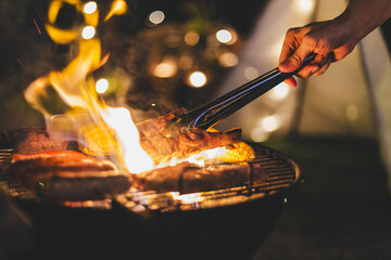 barbecue meat grill in family camping party at night - 677564208