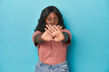 Young african american curvy woman doing a denial gesture